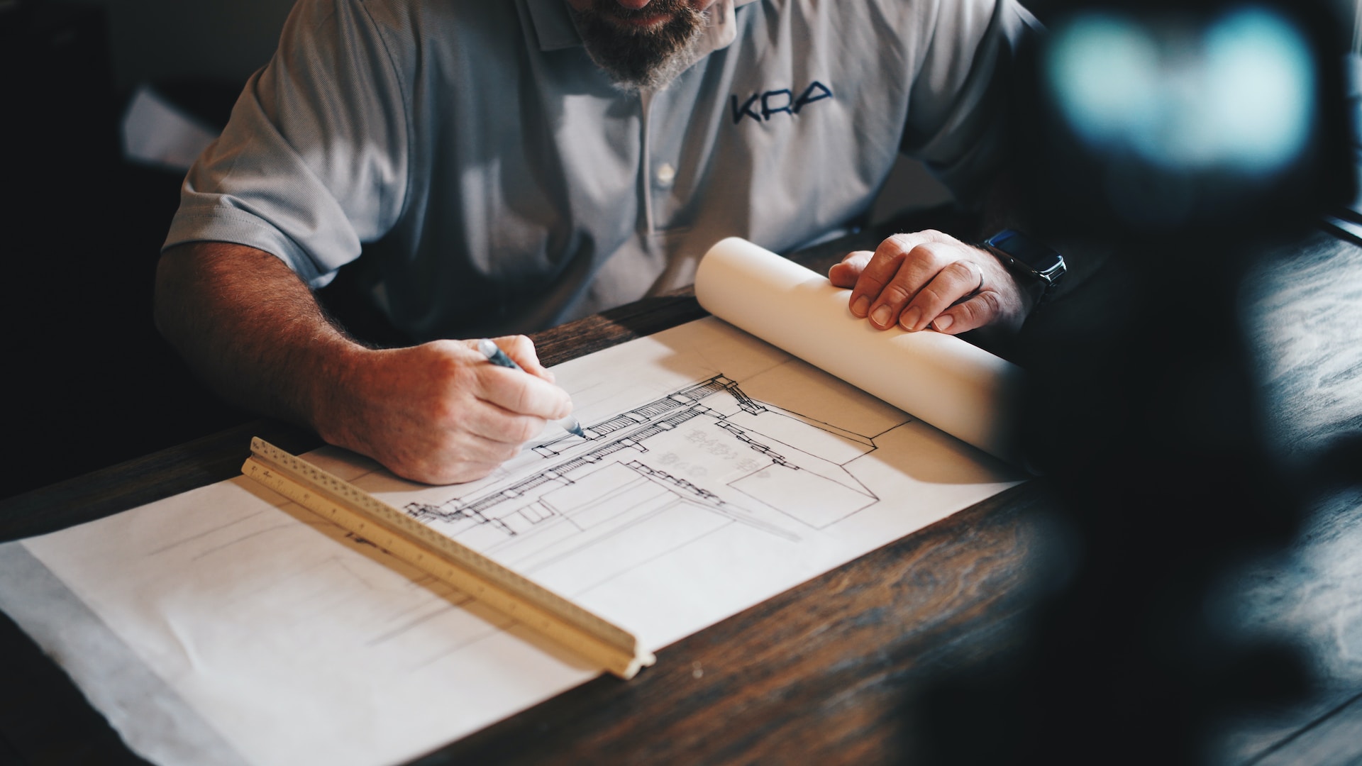 A man working on a technical drawing